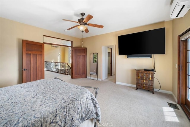 bedroom with a wall mounted air conditioner, ceiling fan, and light colored carpet