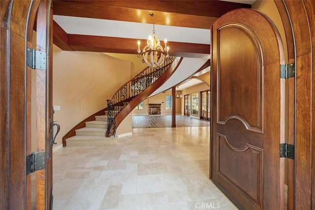 foyer entrance with a notable chandelier