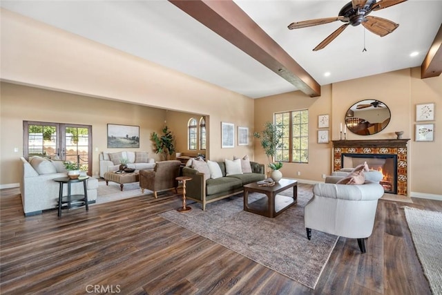 living room featuring ceiling fan, dark hardwood / wood-style floors, a wealth of natural light, and beam ceiling