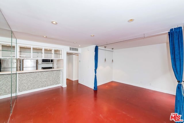 basement featuring stainless steel fridge