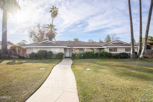 ranch-style home with a front lawn