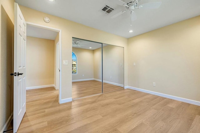 unfurnished bedroom featuring ceiling fan, a closet, and light hardwood / wood-style flooring