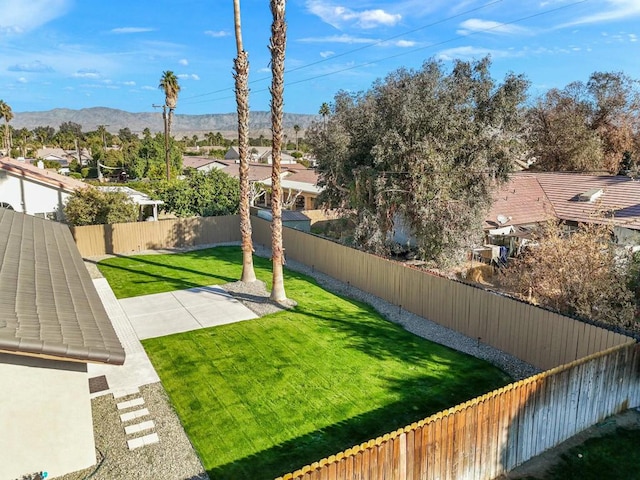 view of yard with a mountain view and a patio