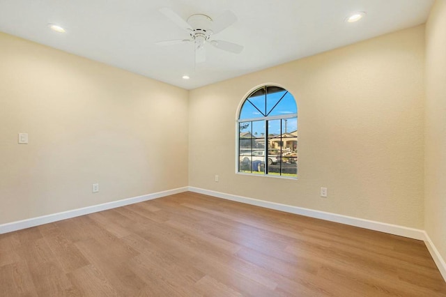 spare room featuring ceiling fan and light hardwood / wood-style flooring