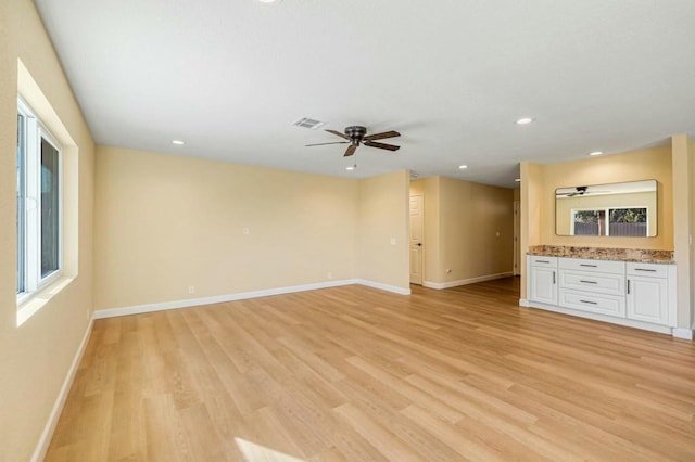 unfurnished living room featuring ceiling fan and light hardwood / wood-style floors