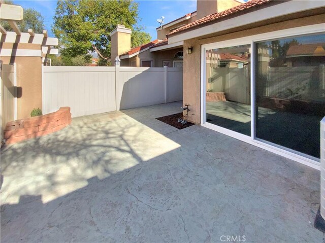 view of patio / terrace featuring fence