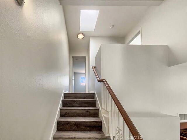 stairs featuring visible vents and a skylight