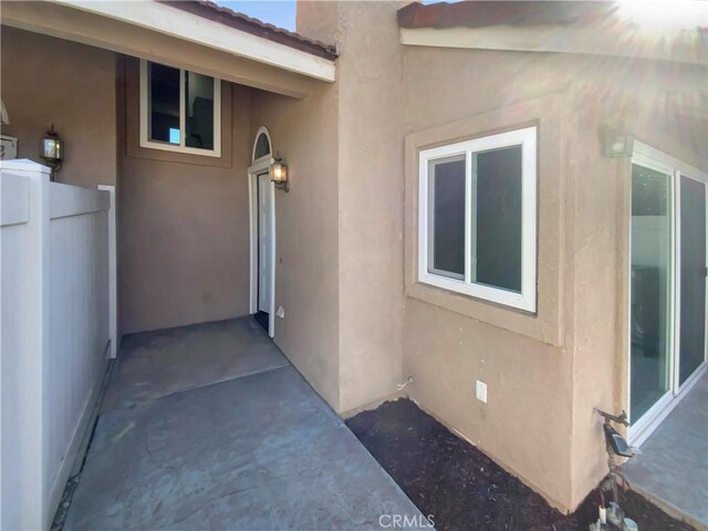 property entrance with stucco siding