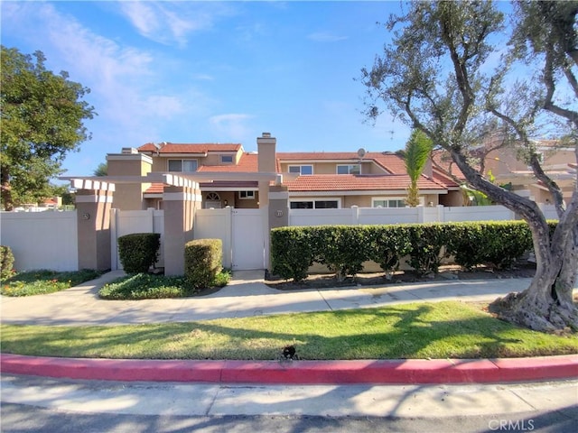 8354 Gabriel Dr Unit B, Rancho Cucamonga, CA 91730 - view of front of house featuring stucco siding, a fenced front yard, a chimney, and a tile roof