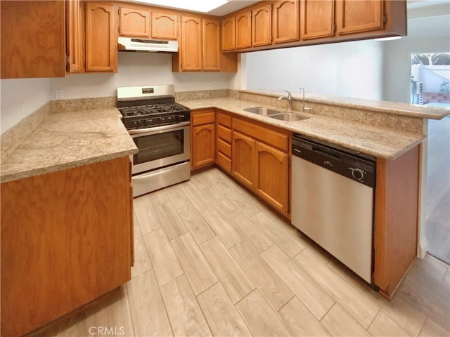 8354 Gabriel Dr Unit B, Rancho Cucamonga, CA 91730 - kitchen featuring appliances with stainless steel finishes, a sink, under cabinet range hood, and brown cabinetry