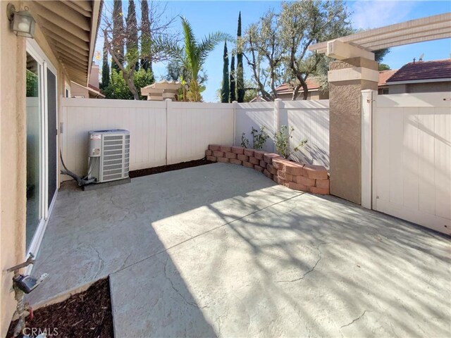 view of patio with central air condition unit and a fenced backyard