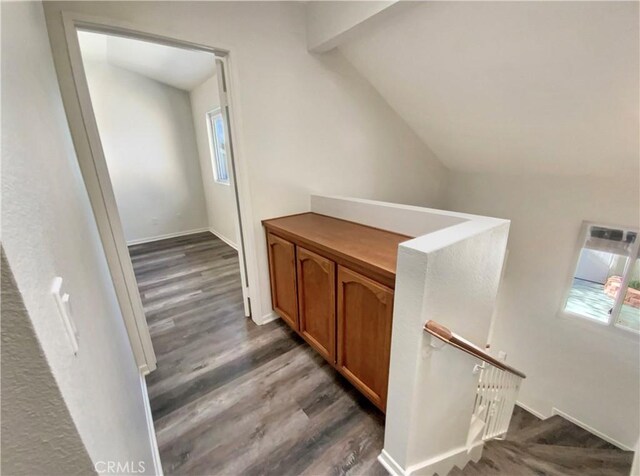 stairs with baseboards, lofted ceiling, and wood finished floors