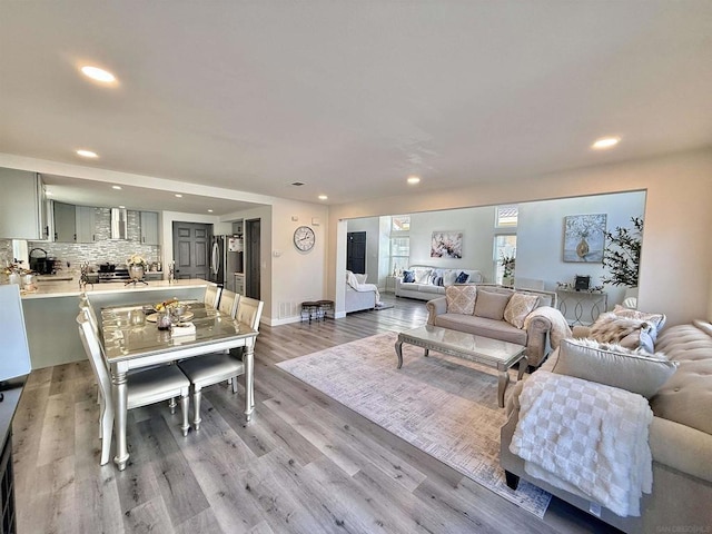 living room featuring sink and light hardwood / wood-style floors