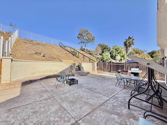 view of patio with an outdoor fire pit