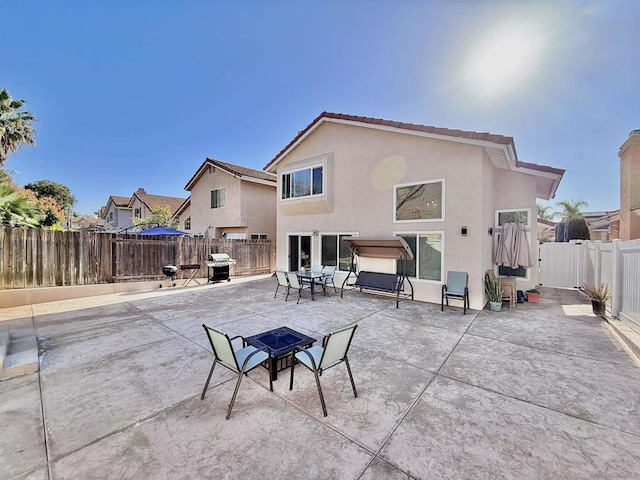 rear view of house featuring a patio