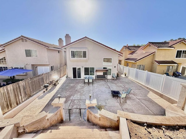 rear view of house featuring a patio