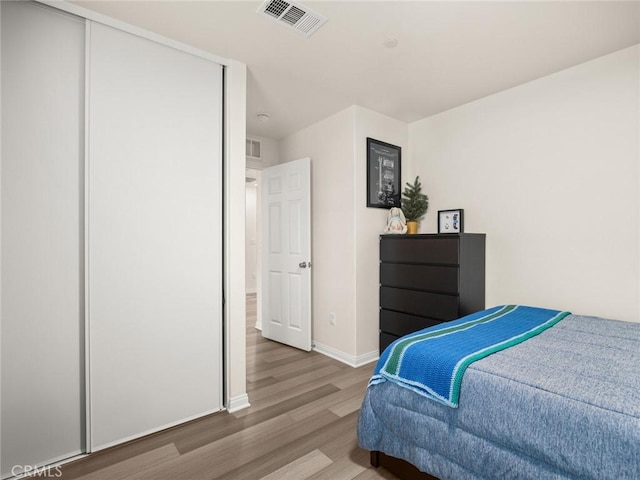 bedroom featuring a closet and hardwood / wood-style floors