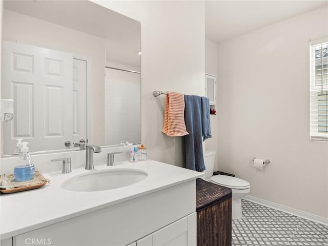 bathroom featuring a shower, vanity, and toilet