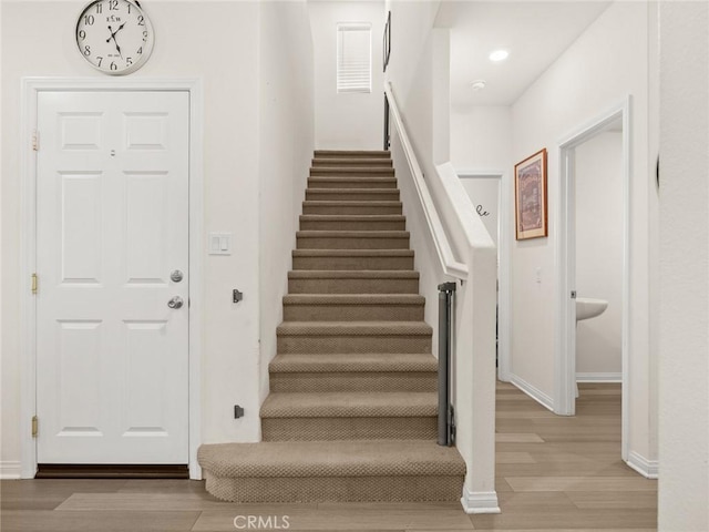 stairway featuring hardwood / wood-style flooring