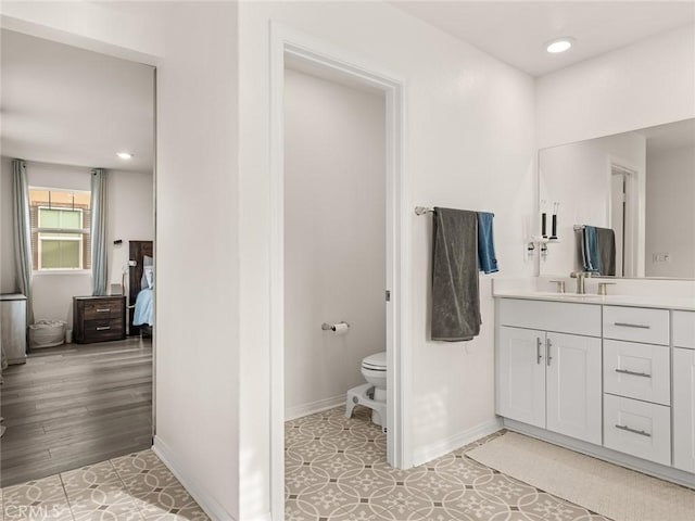 bathroom featuring hardwood / wood-style floors, vanity, and toilet