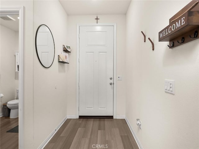 doorway to outside with wood-type flooring