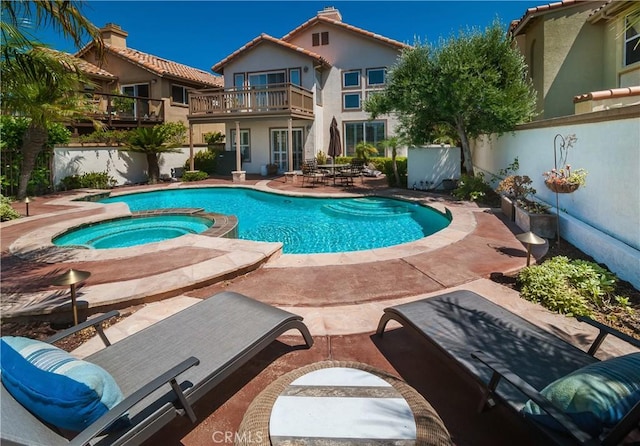 view of swimming pool featuring a patio area and an in ground hot tub