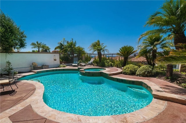 view of swimming pool featuring an in ground hot tub and a patio area