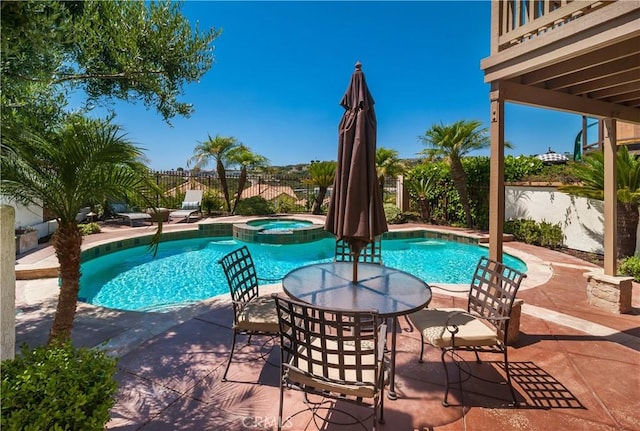 view of swimming pool with a patio area and an in ground hot tub