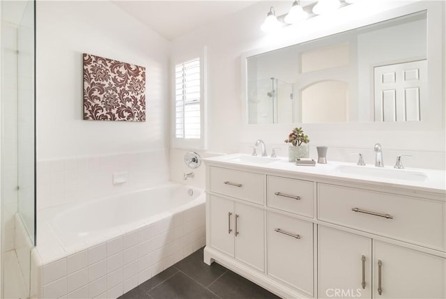 bathroom with vanity, tiled bath, and tile patterned floors