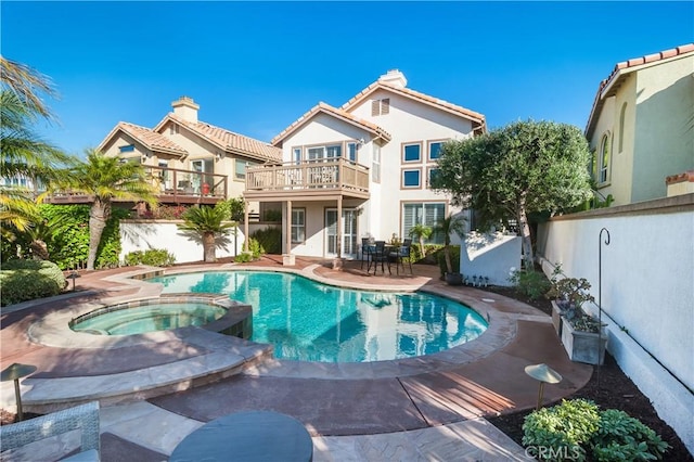 view of pool featuring an in ground hot tub and a patio