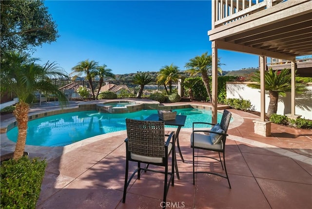 view of swimming pool featuring an in ground hot tub and a patio