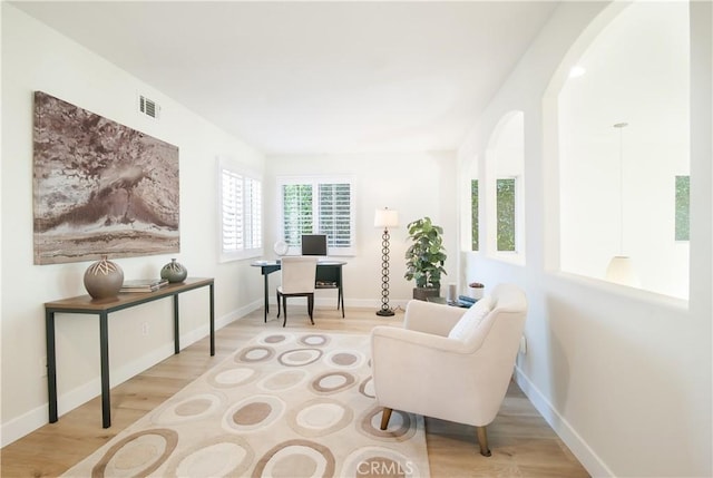 living area with light hardwood / wood-style flooring