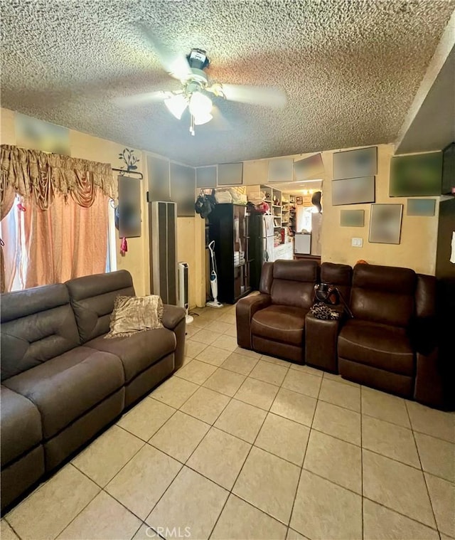 tiled living room with ceiling fan and a textured ceiling