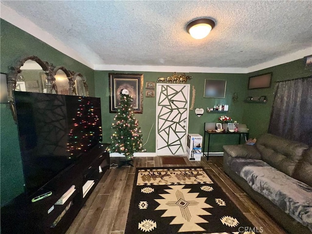 living room with dark hardwood / wood-style flooring and a textured ceiling