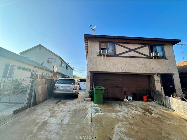 view of front of home with cooling unit and a garage