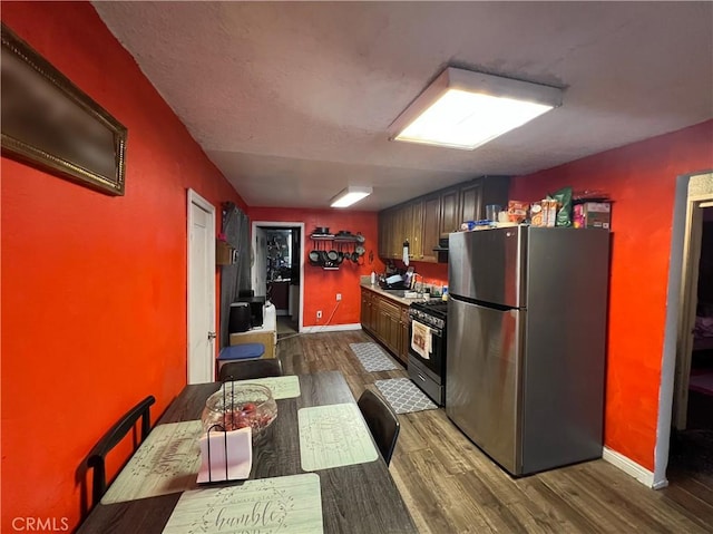 kitchen featuring dark wood-type flooring and appliances with stainless steel finishes