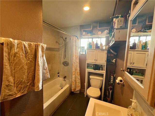 bathroom featuring tile patterned flooring, shower / bath combo, and toilet