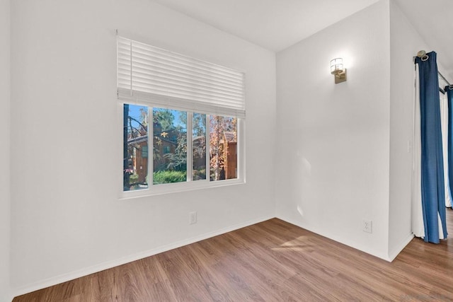 spare room featuring hardwood / wood-style floors