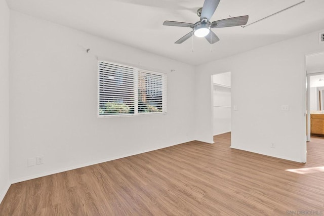 spare room featuring ceiling fan and light hardwood / wood-style flooring