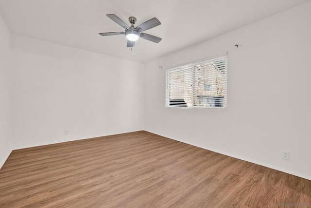 spare room with ceiling fan and light hardwood / wood-style flooring