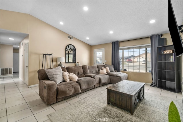 tiled living room with a textured ceiling and lofted ceiling