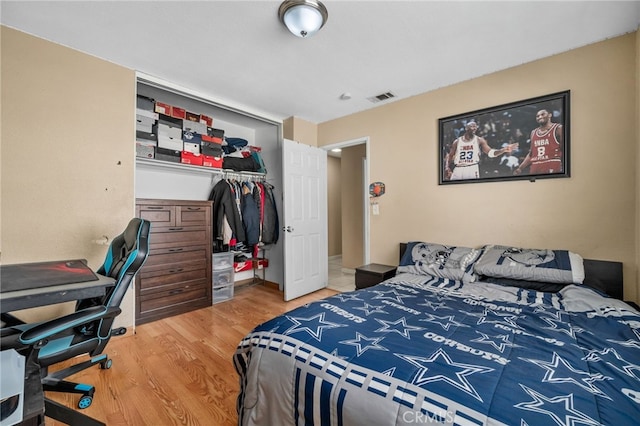 bedroom with a closet and hardwood / wood-style flooring