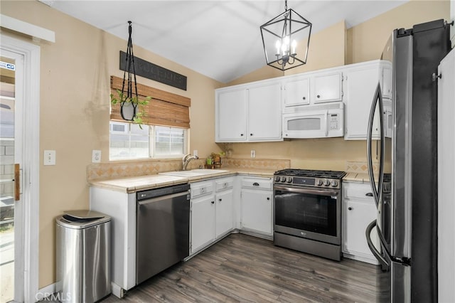 kitchen featuring white cabinetry, stainless steel appliances, an inviting chandelier, sink, and hanging light fixtures