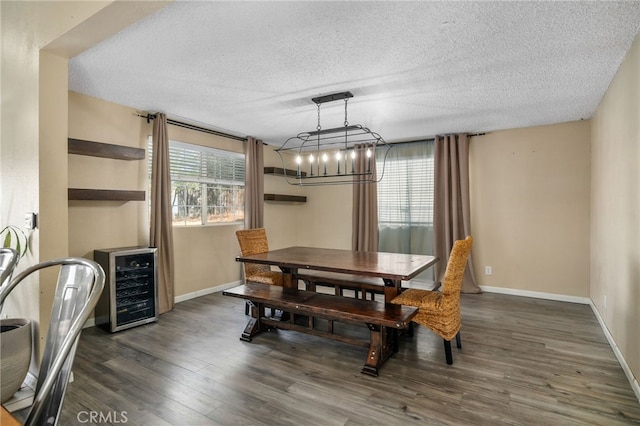 dining room with a textured ceiling, dark wood-type flooring, and wine cooler