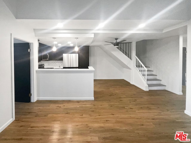 unfurnished living room featuring ceiling fan and dark hardwood / wood-style floors