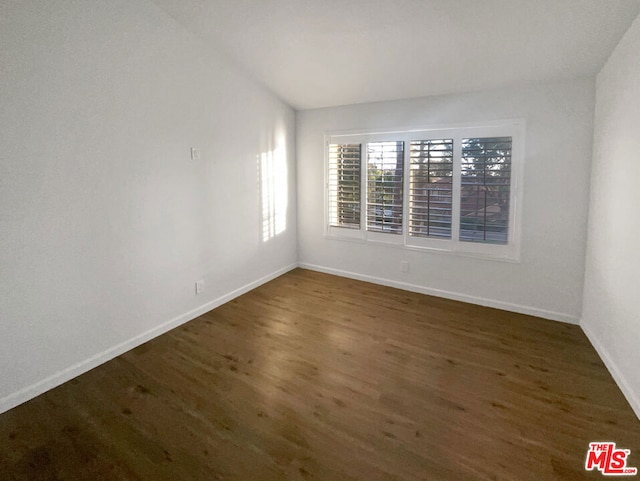 empty room with dark hardwood / wood-style floors