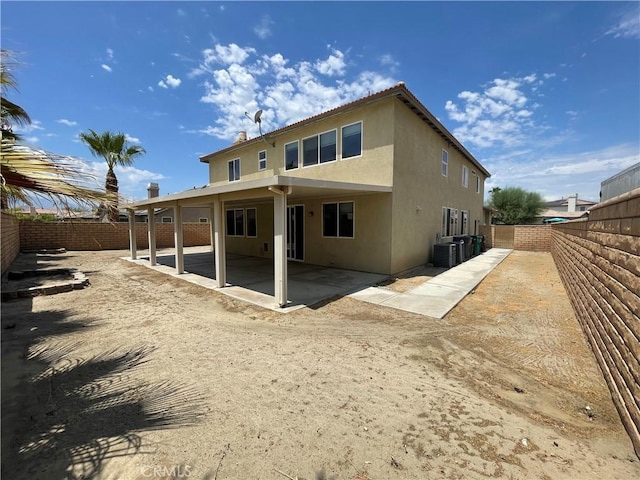 rear view of property featuring a patio and central AC unit