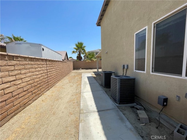 view of property exterior featuring central air condition unit and a patio