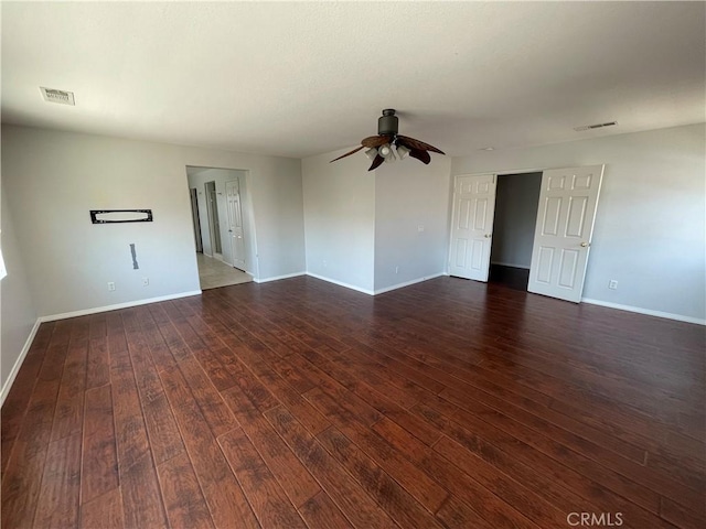 empty room with ceiling fan and dark wood-type flooring