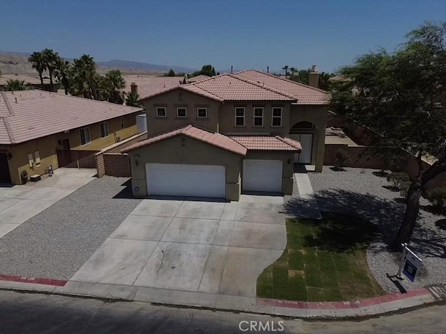 mediterranean / spanish-style home featuring a garage